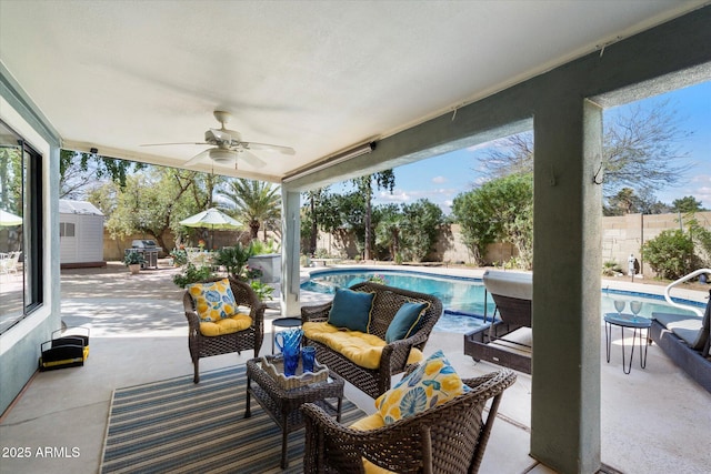 view of patio / terrace featuring an outdoor living space, a fenced in pool, a fenced backyard, and ceiling fan