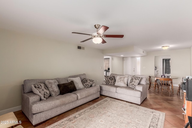 living room featuring ceiling fan and tile patterned floors