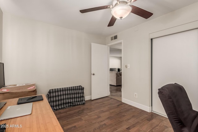 office with dark wood-type flooring and ceiling fan