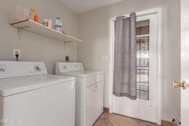 washroom featuring light tile patterned floors and washer and clothes dryer