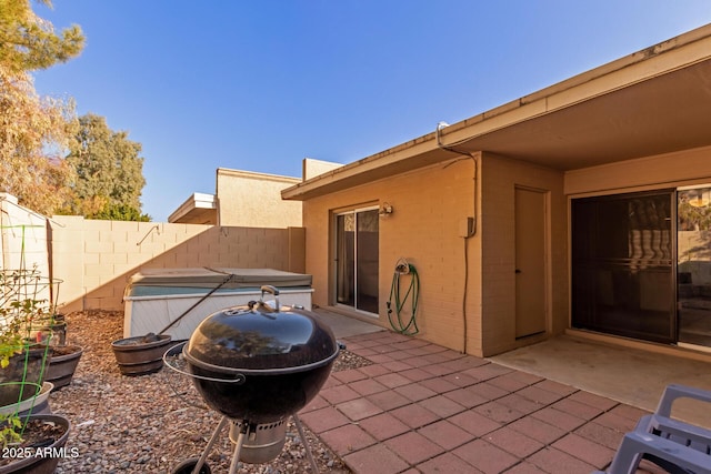 view of patio / terrace with a hot tub and area for grilling