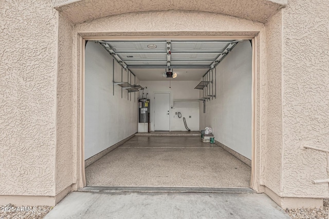 garage with water heater and a garage door opener