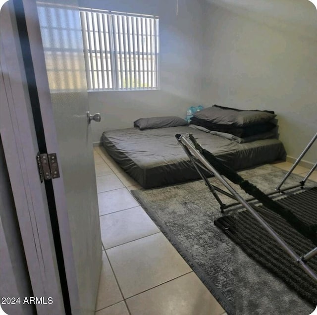 bedroom with light tile patterned floors