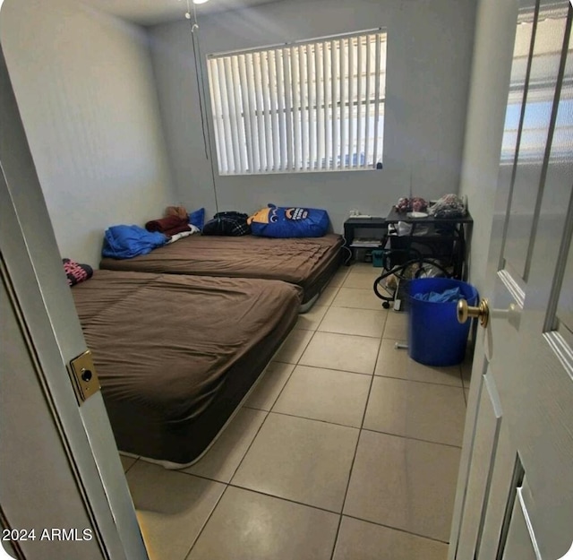 bedroom featuring light tile patterned floors