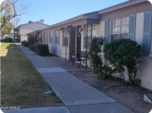 view of home's exterior with a yard