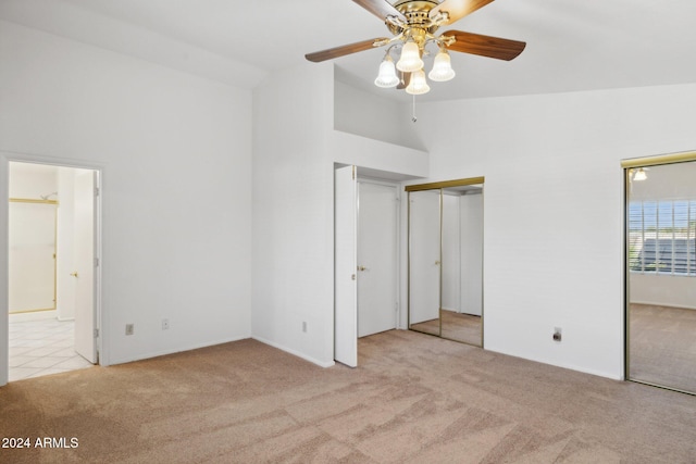 unfurnished bedroom with light carpet, high vaulted ceiling, and ceiling fan