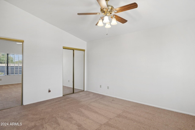 unfurnished bedroom featuring ceiling fan, light carpet, and vaulted ceiling