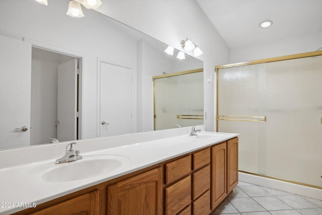 bathroom featuring tile patterned floors, a shower with door, and vanity