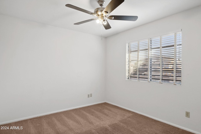 spare room featuring ceiling fan and carpet floors