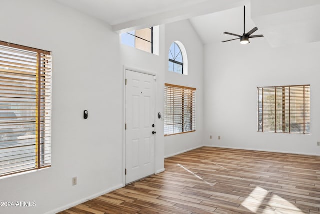 entrance foyer featuring light hardwood / wood-style floors, high vaulted ceiling, and ceiling fan