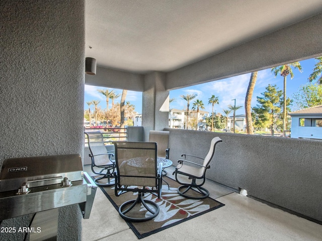 view of patio featuring area for grilling and a balcony