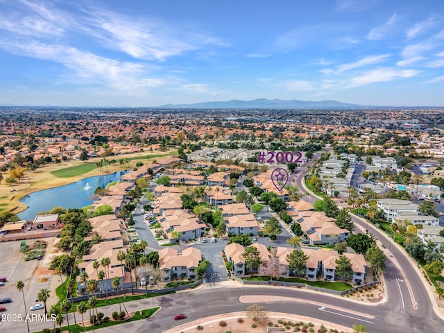 drone / aerial view featuring a water and mountain view