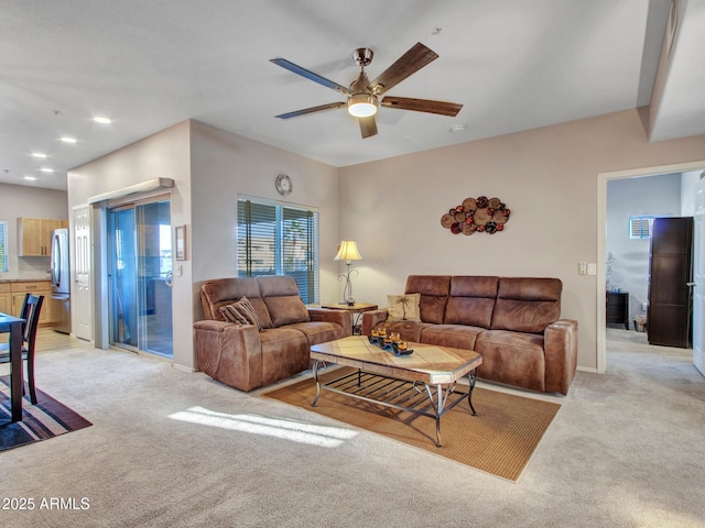 carpeted living room featuring ceiling fan