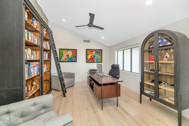 office area with light wood-type flooring, ceiling fan, and vaulted ceiling