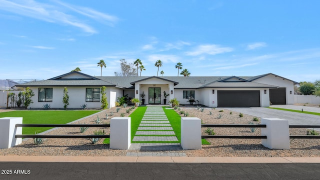 ranch-style house featuring a garage and a front yard