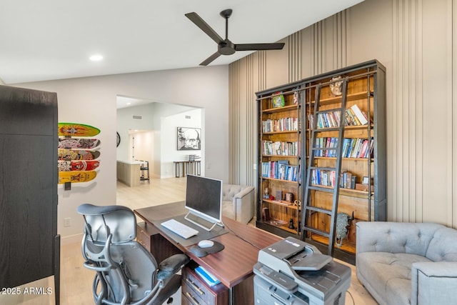 office area featuring ceiling fan, light hardwood / wood-style flooring, and lofted ceiling