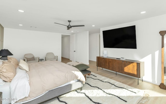 bedroom with ceiling fan and light hardwood / wood-style flooring