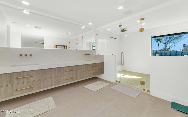 bathroom with tile patterned floors, tasteful backsplash, vanity, and a shower with shower door