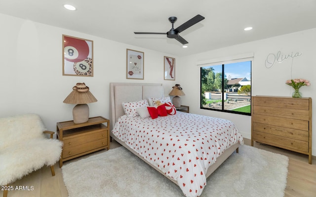 bedroom with ceiling fan and hardwood / wood-style flooring