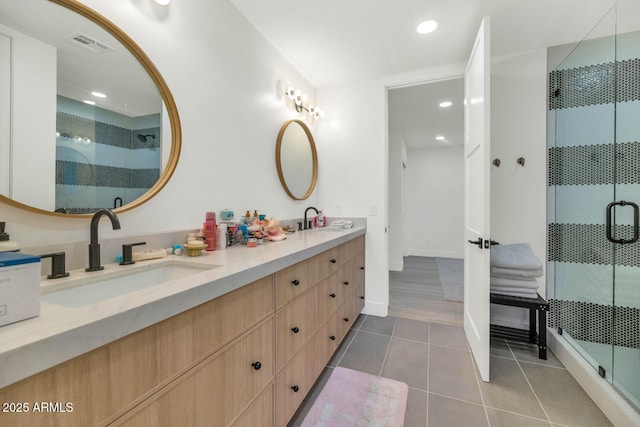 bathroom featuring vanity, a shower with door, and tile patterned floors