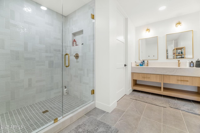 bathroom featuring tile patterned floors, walk in shower, and vanity