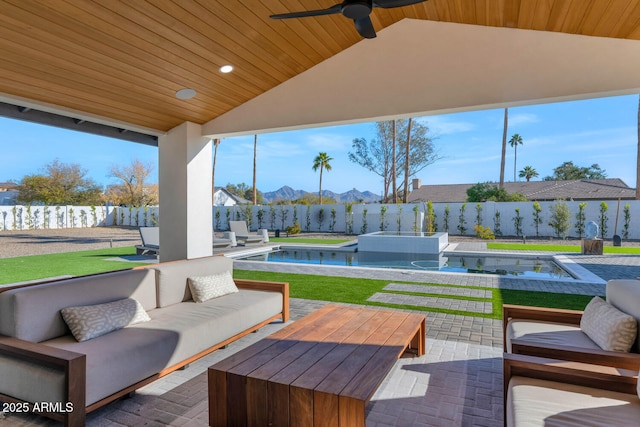 view of patio / terrace with a mountain view, a fenced in pool, an outdoor living space, and ceiling fan