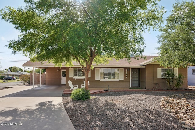 ranch-style house with driveway and a carport