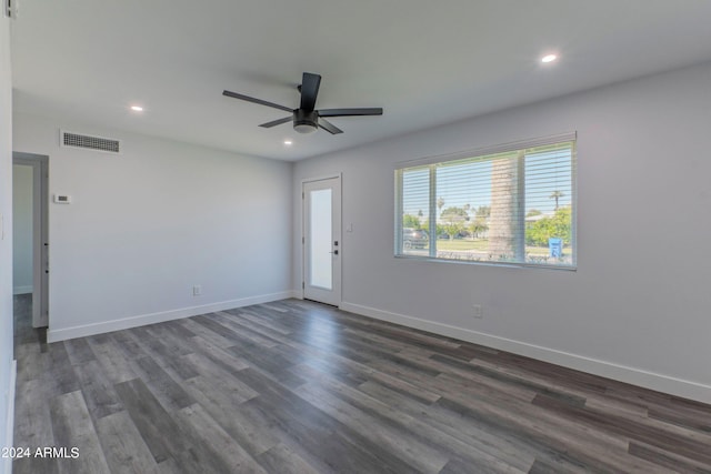 empty room with ceiling fan and dark hardwood / wood-style floors