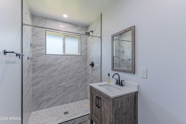 bathroom with vanity and tiled shower