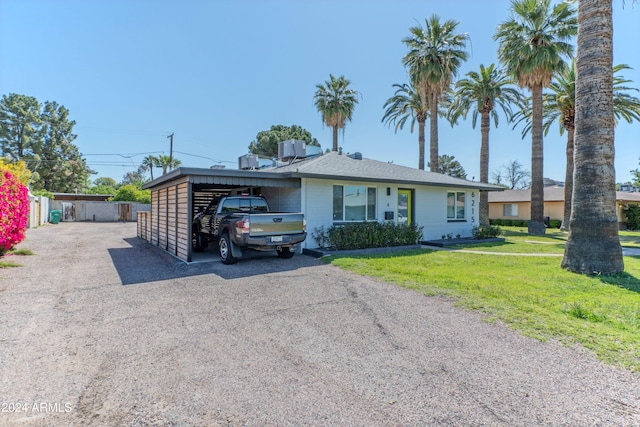 ranch-style house with a front lawn and central air condition unit