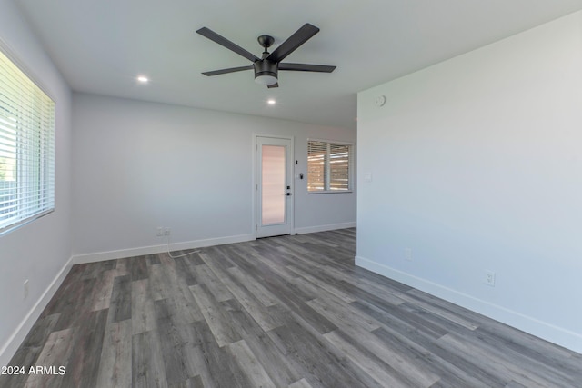 spare room with ceiling fan and dark hardwood / wood-style floors