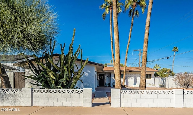 ranch-style home with an attached garage and fence