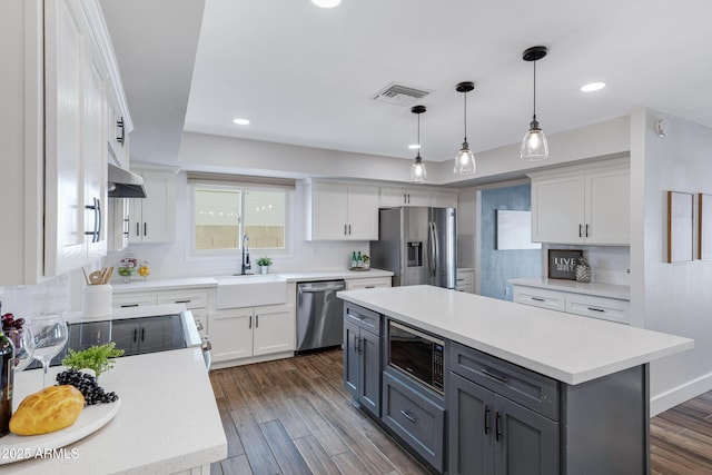 kitchen featuring white cabinetry, visible vents, stainless steel appliances, and a sink