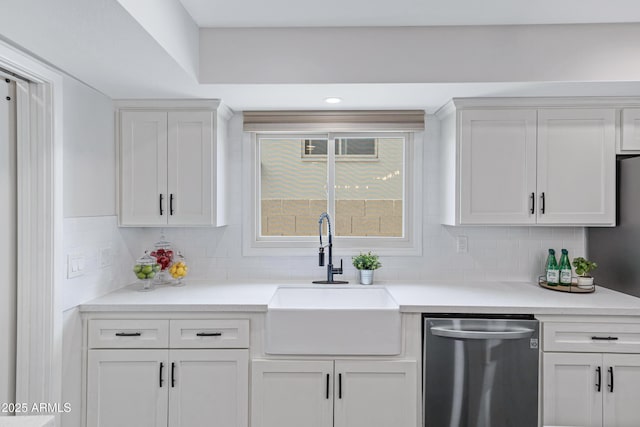 kitchen with decorative backsplash, white cabinetry, dishwasher, and a sink