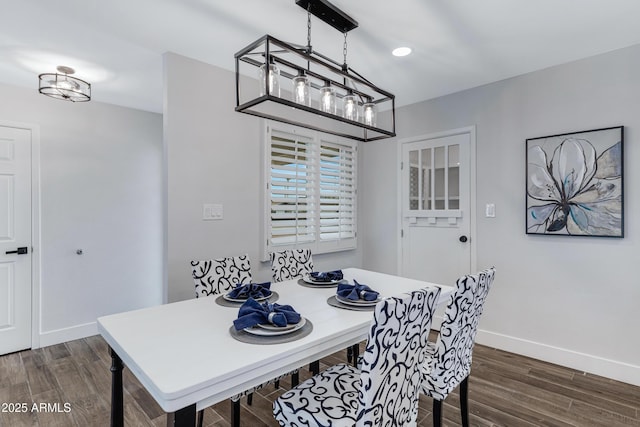 dining area featuring dark wood-style flooring and baseboards