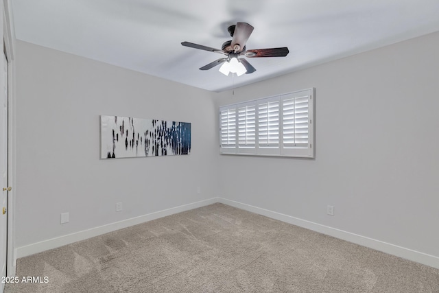 empty room with carpet floors, ceiling fan, and baseboards