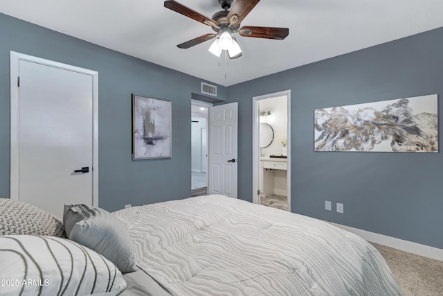 bedroom featuring baseboards, visible vents, ensuite bath, ceiling fan, and carpet floors