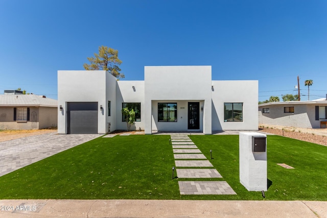 view of front of house with a front yard and a garage