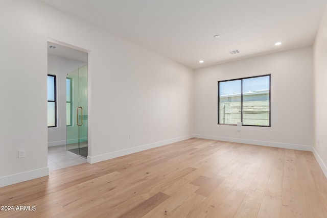 spare room featuring light hardwood / wood-style floors