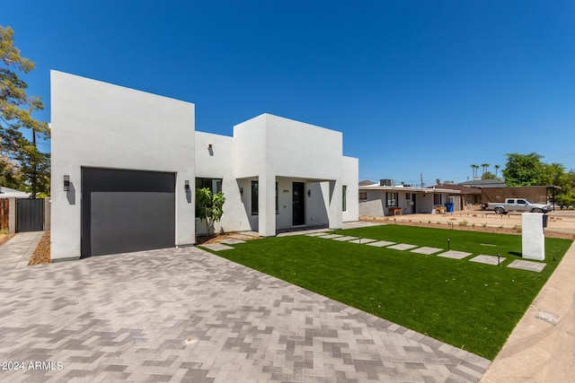 view of front facade with a front lawn and a garage