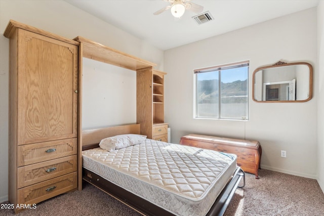 carpeted bedroom featuring baseboards, visible vents, and a ceiling fan