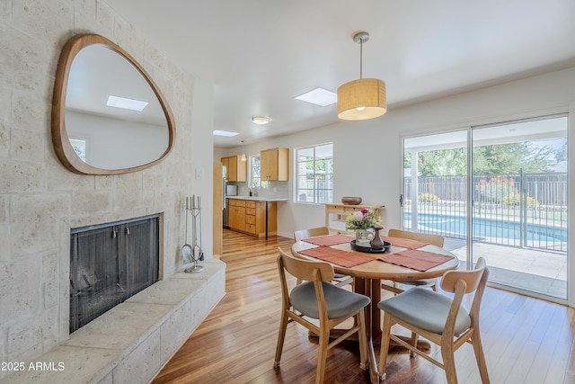 314 E Royal Palm Rd, Phoenix, AZ 85020 - dining space featuring light wood finished floors and a fireplace