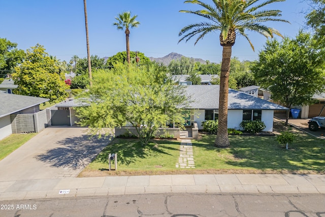 314 E Royal Palm Rd, Phoenix, AZ 85020 - view of property hidden behind natural elements featuring driveway, a mountain view, and a shingled roof