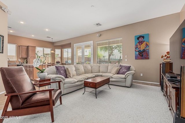 12417 W Apache St, Avondale, AZ 85323 - living room featuring baseboards, recessed lighting, and light carpet