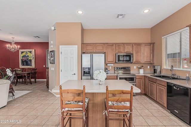 12417 W Apache St, Avondale, AZ 85323 - kitchen featuring appliances with stainless steel finishes, a sink, a chandelier, light tile patterned flooring, and recessed lighting