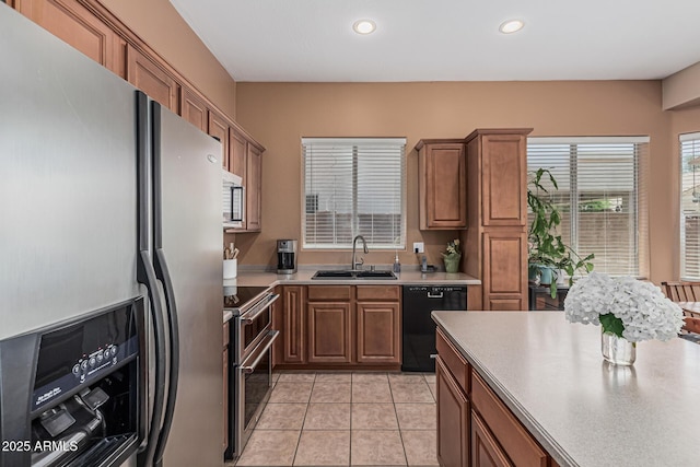 12417 W Apache St, Avondale, AZ 85323 - kitchen featuring stainless steel appliances, a sink, plenty of natural light, brown cabinetry, and recessed lighting