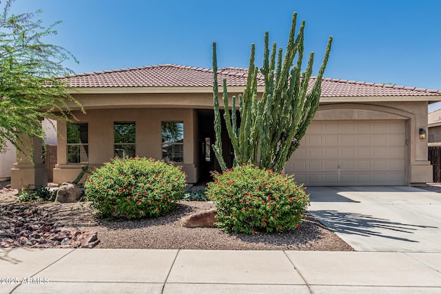 12417 W Apache St, Avondale, AZ 85323 - view of front of house with stucco siding, concrete driveway, an attached garage, and a tiled roof
