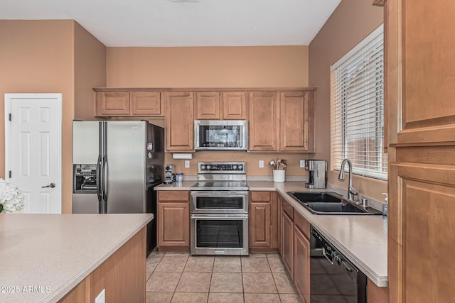12417 W Apache St, Avondale, AZ 85323 - kitchen featuring appliances with stainless steel finishes, a sink, light countertops, and light tile patterned flooring