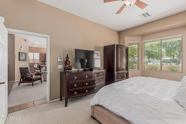 12417 W Apache St, Avondale, AZ 85323 - bedroom with light colored carpet, baseboards, and a ceiling fan