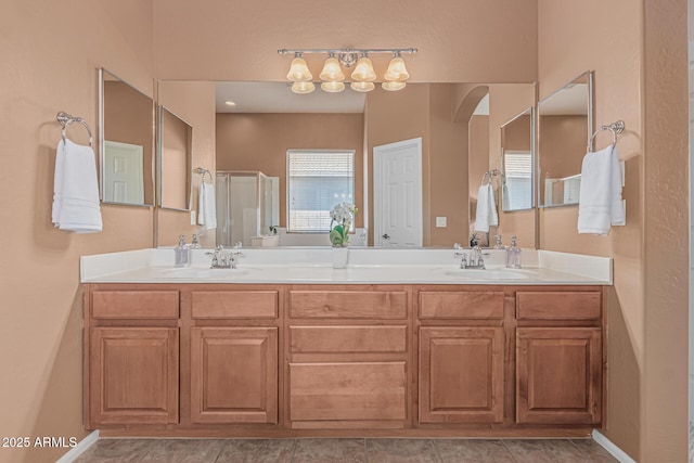12417 W Apache St, Avondale, AZ 85323 - bathroom with double vanity, an enclosed shower, and baseboards